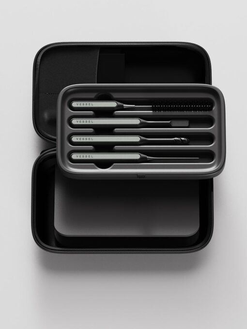 The Care Kit features a sleek black case with five precision metal tools labeled VESSEL, including a brush, all neatly arranged in a foam insert. The open case displays its well-organized interior.