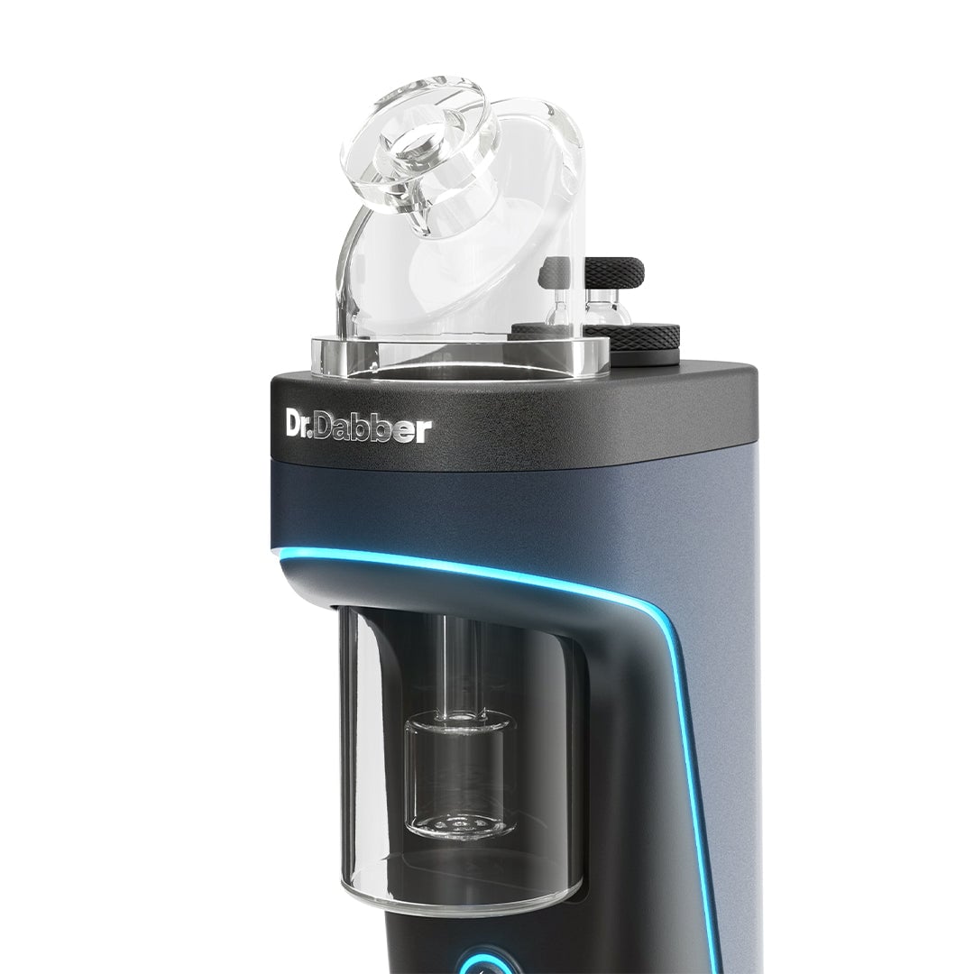 A close-up of the Dr Dabber Switch 2 electronic dab rig, showcasing its transparent glass attachment and curved blue LED accent on a sleek black and gray body.