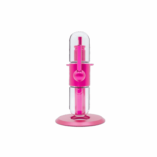 The Stündenglass Kompact Gravity Infuser in pink features a modern cylindrical design with a transparent center and round base, taking inspiration from the original Stündenglass, and is shown against a plain white background.