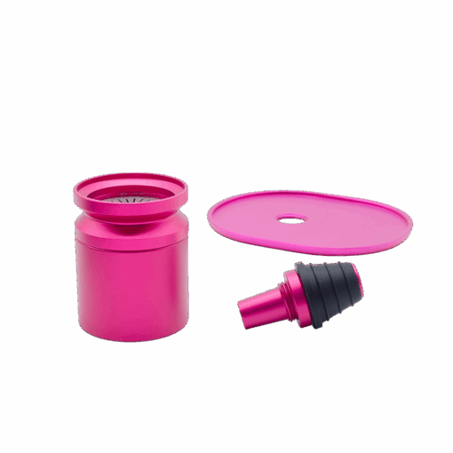 The Stündenglass Kompact Gravity Infuser in pink features a modern cylindrical design with a transparent center and round base, taking inspiration from the original Stündenglass, and is shown against a plain white background.