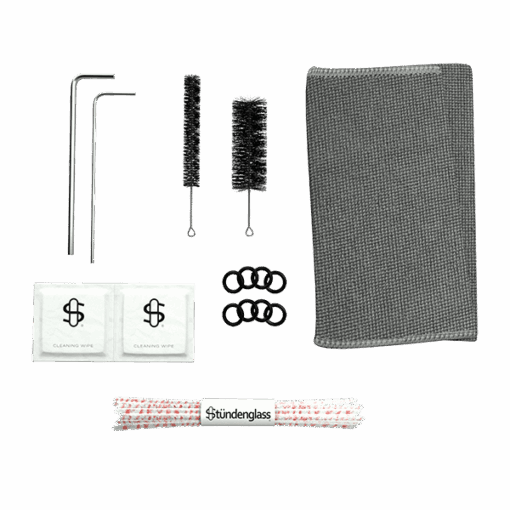 Cleaning kit for your Stündenglass Kompact Gravity Infuser - Pink shown on a white background with two metal rods, two cleaning brushes, a gray textured cloth, two wipes, black rubber rings, and a Stündenglass pipe cleaner.