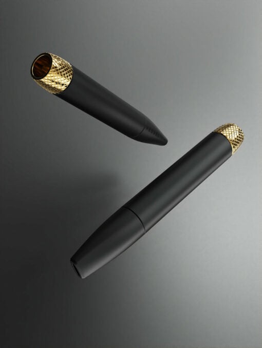 Two Helix [Matte Black] pens with textured gold caps float against a gradient gray backdrop. One pen’s cap is removed, revealing its sleek, helix-patterned metallic interior.