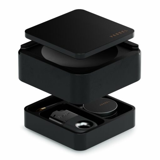 A black, square storage box called Ash [Black] with a removable lid, shown open to reveal organized compartments holding various small smoking accessories and containers.