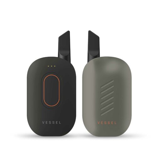 Compass [Yosemite] +, a sleek matte gray vape device with subtle diagonal accents, stands upright displaying VESSEL branding. An earlier Compass version in black with orange detail and indicator lights stands beside it.