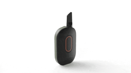 The Compass [Yosemite] + is a black, oval electronic device with an orange-ringed front button and a flip-up USB connector on top, rotating on a white background—evoking the spirit of digital navigation for Yosemite explorers.