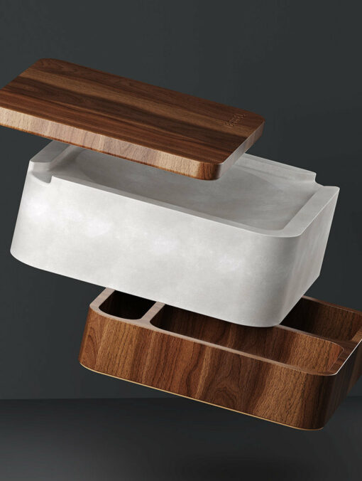 Ash is a modern, minimalist container featuring three separated parts: a dark wooden lid, a white marble-like central section, and a dark wooden base, all appearing to float above each other against a dark background.