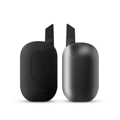 Two sleek, gunmetal-black Compass [Gunmetal] devices with minimalistic oval design are shown on a white background: one has three blue LED lights and a circular indentation, the other is smooth with a matte finish.