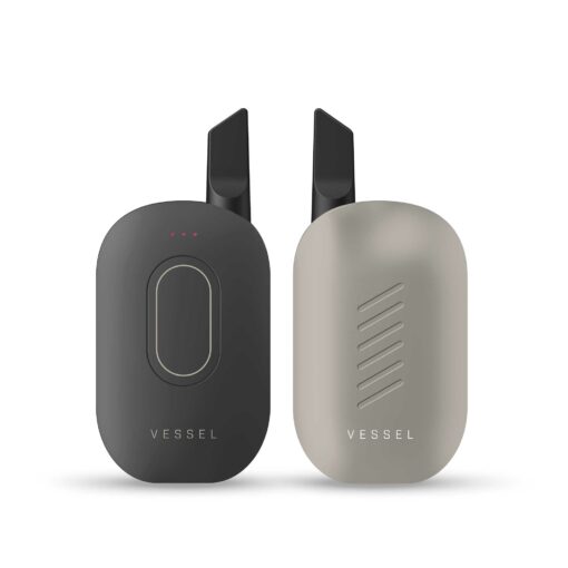 Two sleek, oval-shaped black and gray Compass [Mojave] + devices with black mouthpieces are displayed side by side against a white background, highlighting the refined Mojave-inspired design of the VESSEL Compass collection.