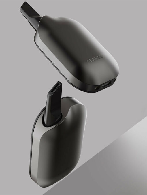 The Compass [Gunmetal] + vape device, with a sleek matte black and gunmetal finish, floats against a gray backdrop, showcasing its smooth curved design and mouthpiece from various angles in a modern, stylish display.