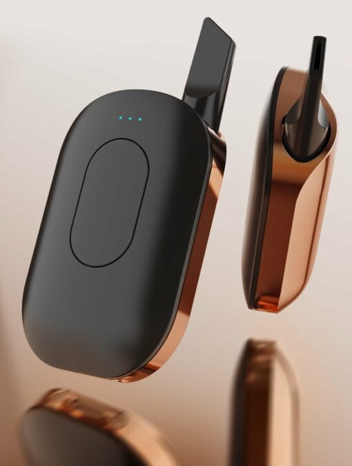 The Compass [Copper] +—a modern black and copper device with indicator lights, one showing a mouthpiece, the other encased—rests on a neutral background, radiating sleek style and directional sophistication.