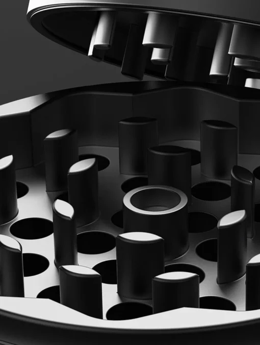 Close-up of the Drift Case [Gunmetal] interior, featuring interlocking cylindrical and rectangular teeth, with the partially open lid displayed against a dark background.