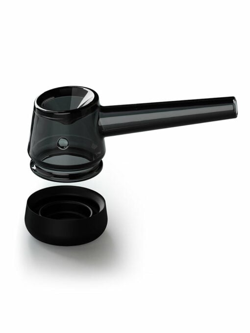 The Forge [Black] glass pipe features a transparent black finish, a cylindrical bowl, and a long stem, showcased suspended above its round black silicone base against a white background.