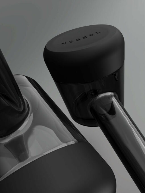 Close-up of the Forge [Black] container, featuring a sleek glass and matte black design with “VESSEL” embossed on the lid, set against a gray background. The minimalistic style combines modern aesthetics with practical function.