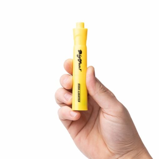 A hand holds a yellow BIGFUN! High-Lighter Vaporizer marker with a chisel tip against a white background, featuring black text and branding printed on its body.