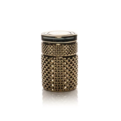 The Twenties Collection Jar | Gold is a cylindrical jar with a textured, pyramid-studded surface, displayed on a white background with a subtle reflection below.