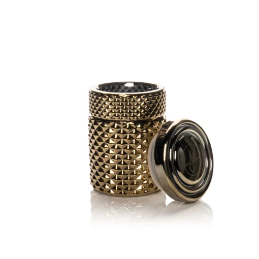 The Twenties Collection Jar | Gold is a textured, cylindrical gold jar with a geometric studded pattern, shown open with its matching lid beside it on a white background.
