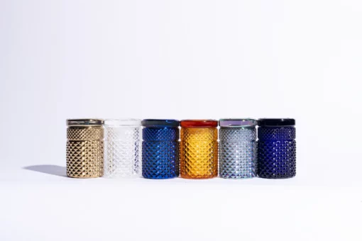 The Twenties Collection Jar in gold, a textured glass jar with lid, is displayed on a white background as a stylish container.