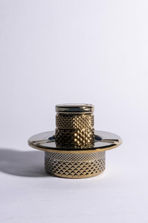 The Twenties Collection Ashtray | Gold is a metallic, cylindrical piece featuring a textured lattice design and shiny flat top and base, shown against a plain white background.