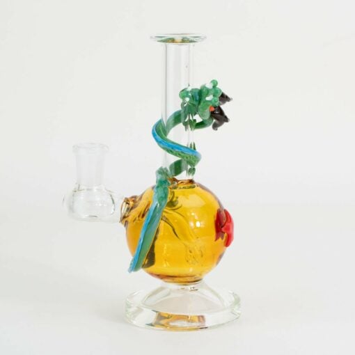 The Empire Glassworks Dragon Sphere Mini-Tube features a round amber base, a blue and green glass dragon coiled around its neck, and a red accent on the side, all shown against a plain white background.