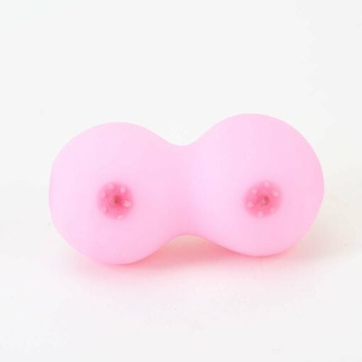 A pink silicone object, shaped like two joined circles with raised dots in the center—evoking the playful design of the Empire Glassworks Boobies Dry Pipe—rests on a white background.