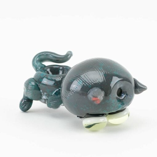 A small, dark green glass cat sculpture in the playful Empire Glassworks style, featuring a round body, raised tail, yellow eyes, and red nose—modeled after the Empire Glassworks Galacticat Dry Pipe—shown on a white background.