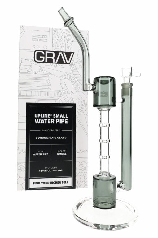 A clear gray GRAV Smoke Upline Bong – 14″ made of borosilicate glass stands before its packaging, which features the GRAV brand and product details in a modern, minimalist design.