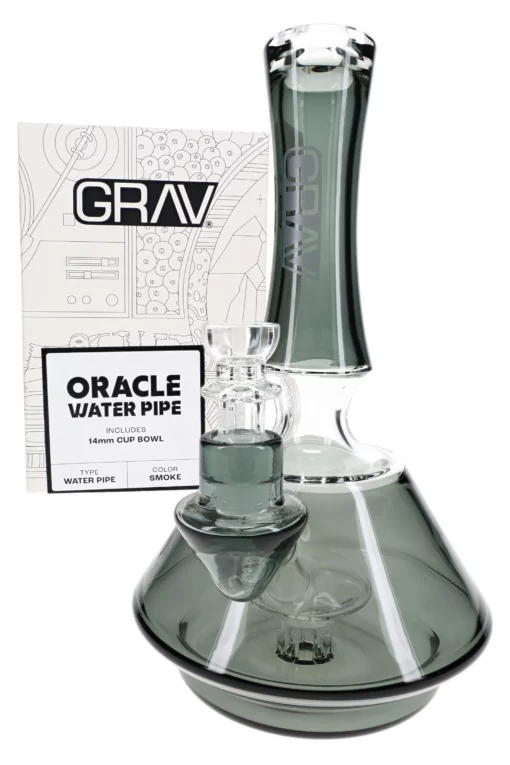 The GRAV Smoke Oracle Bong – 9″ in sleek smoke gray glass is shown in front of its branded packaging, featuring a modern, minimal design with product details.