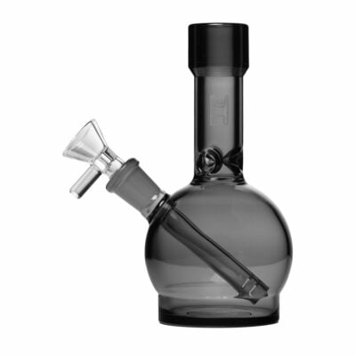 The Human Grade 6" Ball Water Pipe is a transparent, smoky gray piece with a round base, angled mouthpiece, and removable bowl, made from human grade materials and shown on a white background.