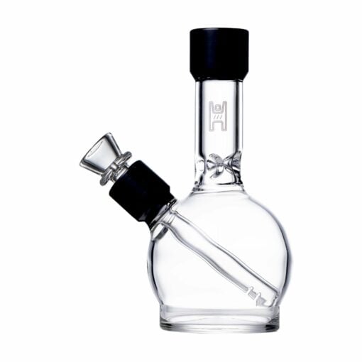 The Human Grade 6" Ball Water Pipe is a clear glass bong with a round base, angled downstem, and removable bowl. It features minimal black accents and a simple, sleek design.