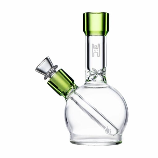 The Human Grade 6" Ball Water Pipe is a small, clear glass pipe with green accents on the mouthpiece and bowl, a round ball-shaped base, and an angled downstem. Made from human grade materials for safe use.