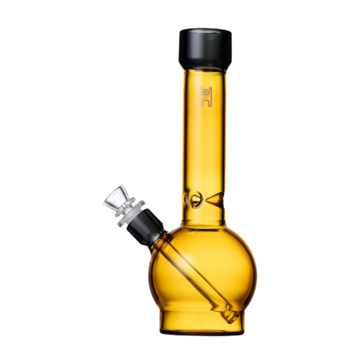 The Human Grade 12" Ball Water Pipe is translucent amber, crafted from human grade materials. It has a round base, a 12-inch cylindrical neck, and an angled clear glass bowl near the bottom.