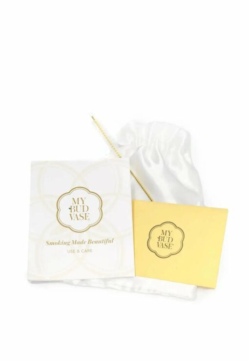 The Stardust Vase Bong's instruction booklet, yellow card, cleaning tool, and white satin pouch are displayed on a white background.