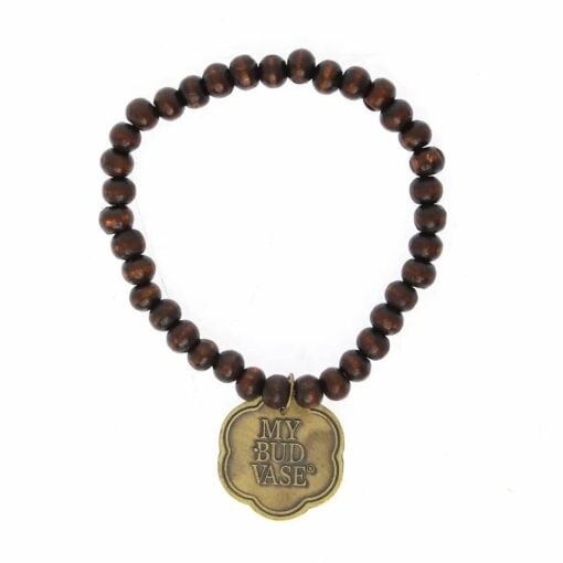 A beaded bracelet made of dark brown wooden beads features a bronze-colored, flower-shaped charm engraved with MY BUD VASE—an ideal accessory for TocaCabana Vase Bong fans. Displayed in a circular layout on a white background.