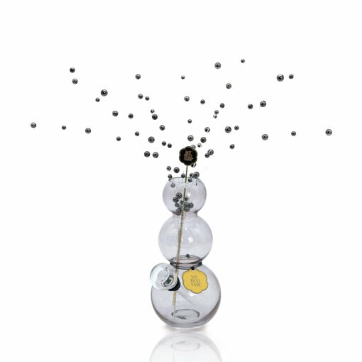 The Bubbles Vase Bong is a clear, sculptural piece with three stacked round sections, featuring black sticks topped with silver spheres for a dynamic, modern look against a white background.