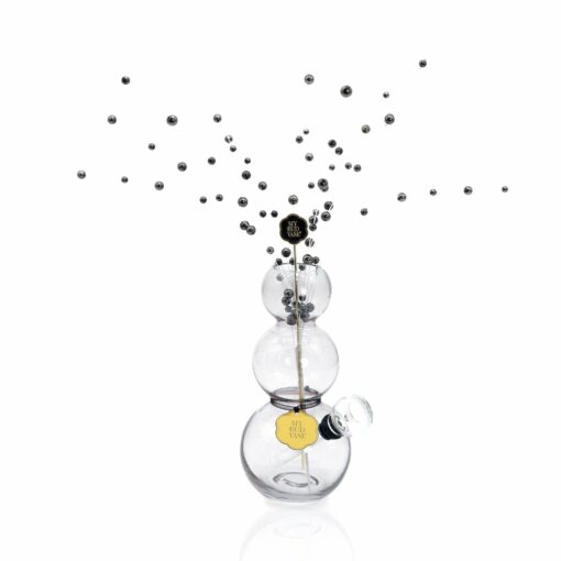 The Bubbles Vase Bong features three clear stacked spheres holding a stick with small metallic balls, with more metallic balls floating above, all set against a white background.
