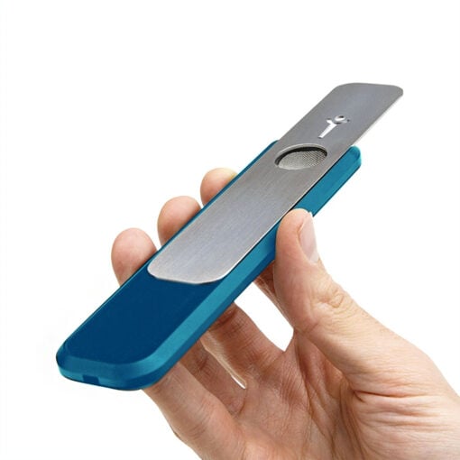 A hand holds the Blue Mini Genius Pipe, a slim and modern device with a metal and blue plastic design, featuring a small round mic or speaker and a stick figure icon on the metal surface, shown against a white background.