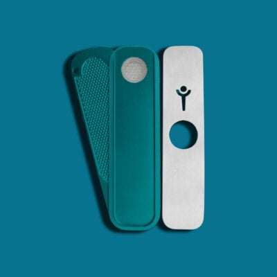 The Blue Mini Genius Pipe is a metal multitool with three pivoting panels—one textured, one smooth with a circular screen, and one silver featuring a hole and minimalist person icon—set against a blue background.