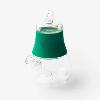 The Bubbler - Forest is a modern clear glass bubbler water pipe with a forest-green silicone neck band, mouthpiece, and angled downstem, shown against a white background.