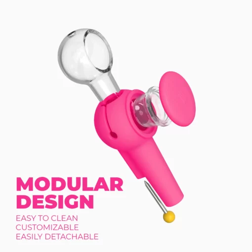 A modular, detachable device called The Pipe - Hot Pink, featuring glass and vibrant pink plastic parts, is displayed on a white background. Text reads: Modular Design. The Pipe - Hot Pink is easy to clean, customizable, and simple to detach.