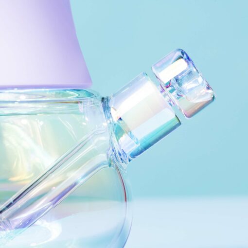Close-up of the neck and stopper of The Iridescent Bubbler - Lavender against a light blue background, displaying its modern, elegant design and pastel-colored lid.