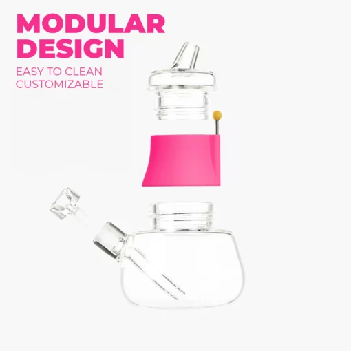 The Bubbler - Hot Pink: A clear, modular glass bubbler with a standout hot pink midsection and a yellow-tipped stick. Bold text reads MODULAR DESIGN; smaller text notes EASY TO CLEAN, CUSTOMIZABLE smoking accessory.