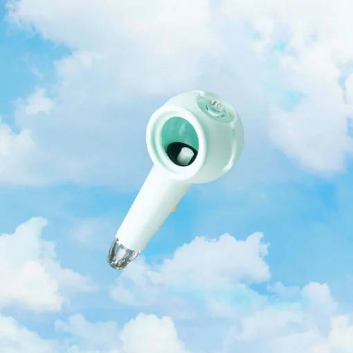 The Pipe Iridescent - Sky, a mint-green, futuristic piece with a transparent tip, floats against a bright blue backdrop filled with fluffy white clouds.