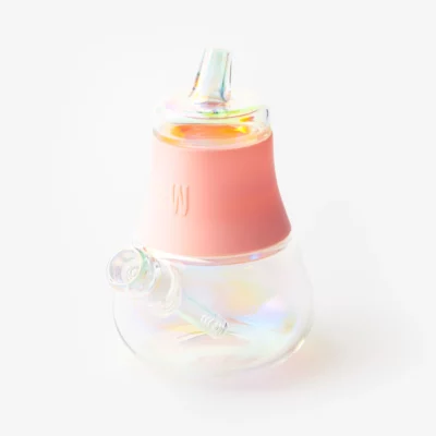 The Bubbler Iridescent - Bubblegum is a clear glass water pipe with an iridescent finish, a bubblegum pink silicone band at the top, and a side percolator stem, shown on a white background.