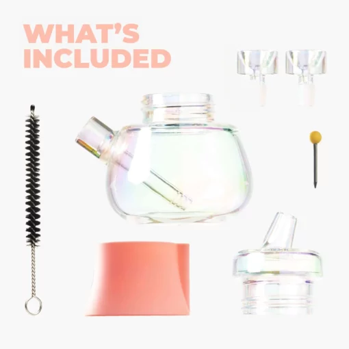 A set of items on a white background: The Bubbler Iridescent - Bubblegum teapot, two glass spouts, black cleaning brush, bubblegum pink silicone base, glass lid, and yellow-tipped tool. The text reads WHAT'S INCLUDED.
