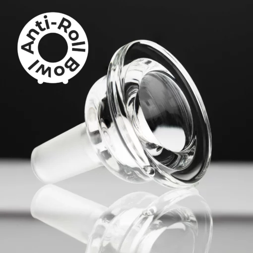 A clear glass bowl with a wide rim, perfect for The Gravity Bong - Forest, sits on a reflective surface. “Anti-Roll Bowl” appears in a white circle at the top left. The background features black and white tones.