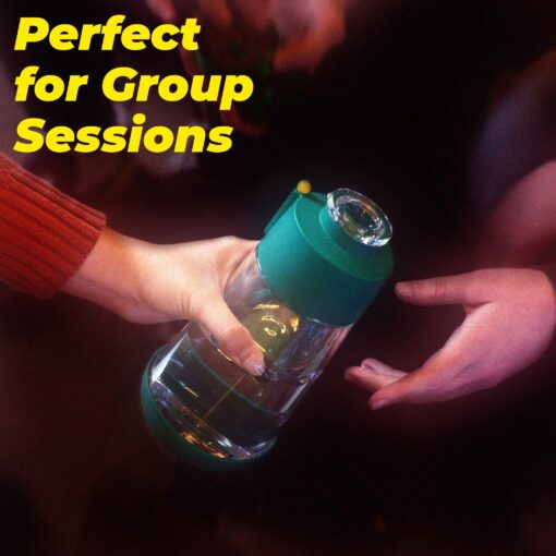 Two people share The Gravity Bong - Forest, its green silicone cover and glass body highlighted against a dark background. Above them, yellow text declares: “Perfect for Group Sessions.”.