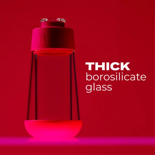 The Gravity Bong - Hot Pink features thick borosilicate glass in a modern design, showcased against a vibrant pink background. Illuminated from below, white text highlights its stylish and durable construction for use as a Gravity Bong.