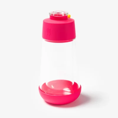 The Gravity Bong - Hot Pink features a clear jar with a wide hot pink base and lid, a small yellow button, and a transparent center, displayed against a plain white background.