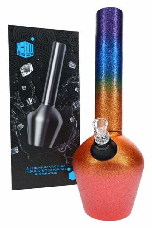 The Chill Glitterbomb Steel Bong – Limited Edition – 13″ features a vibrant gradient with a shiny orange base and purple top, shown beside black packaging adorned with water splashes, ice cubes, and the label "Chill: A Premium Vacuum Insulated Smoking Apparatus.