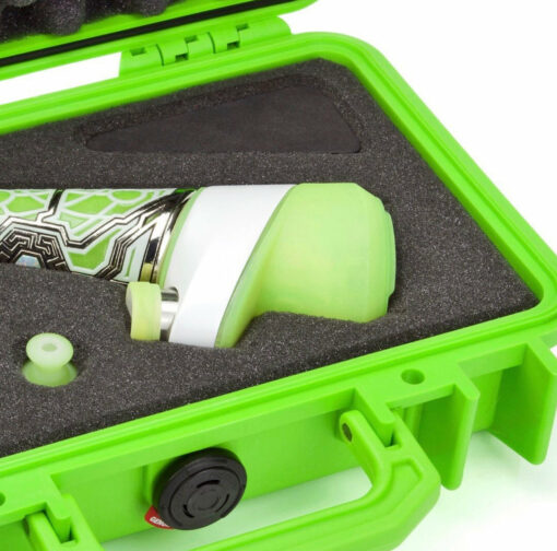 The Ryan Fitt Neon Puffco Peak Complete Set features a patterned cylindrical piece with a green cap, secured in black foam inside a bright green case, along with additional foam slots for a small part and black wedge-shaped accessory.